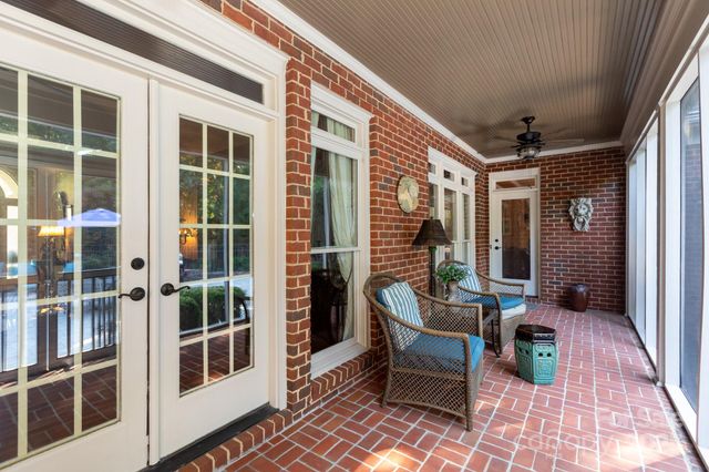 a balcony with furniture and wooden floor
