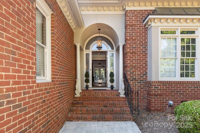 a view of a brick house with large windows