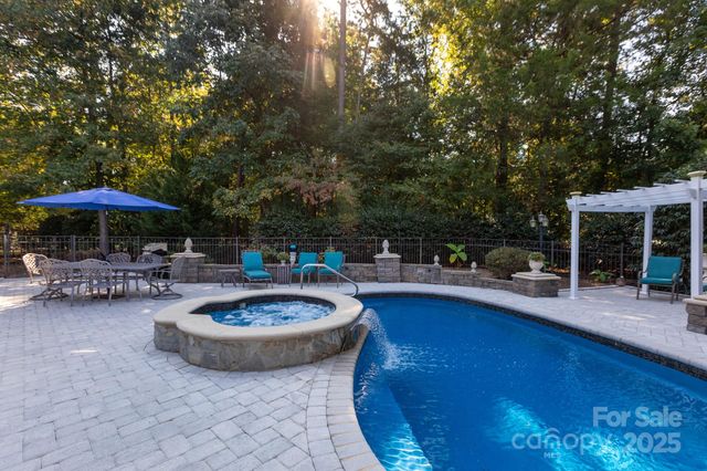a view of a swimming pool with chairs in patio