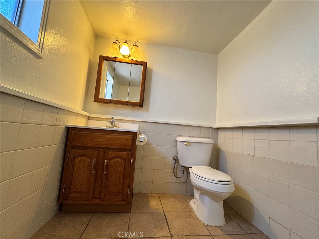 36528 Irwin Road Barstow, CA 92311 - Photo 14 of 35 a bathroom with a toilet a sink and mirror
