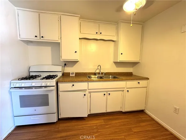a kitchen with stainless steel appliances white cabinets and a sink