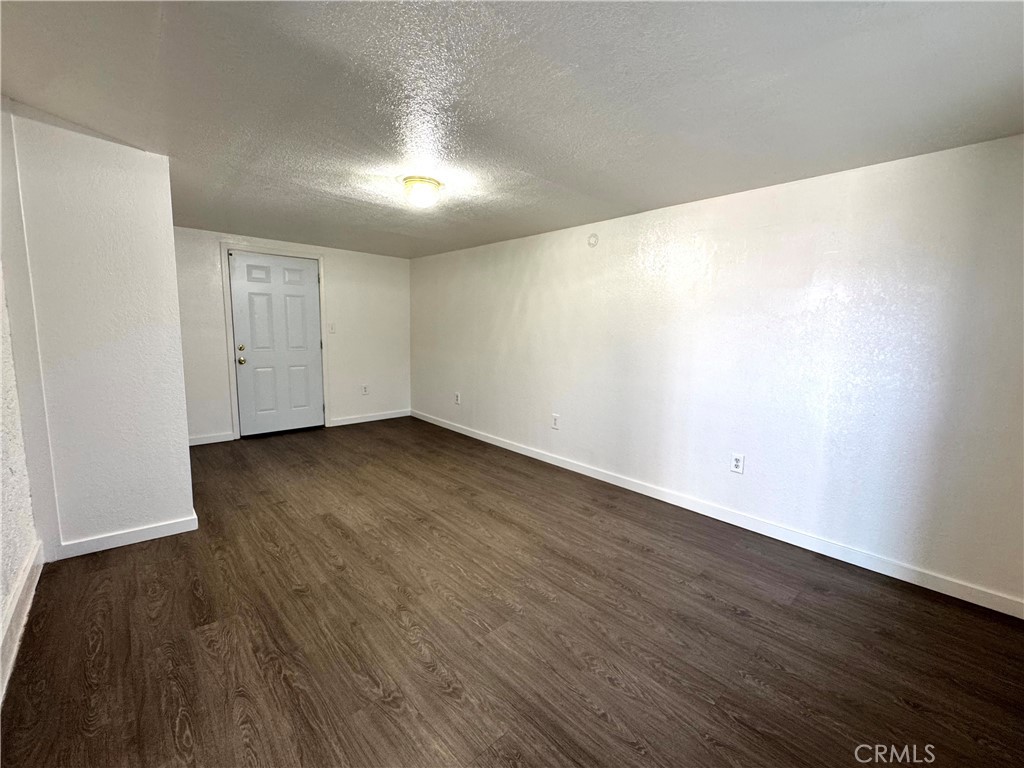 36528 Irwin Road Barstow, CA 92311 - Photo 19 of 35 an empty room with wooden floor and windows