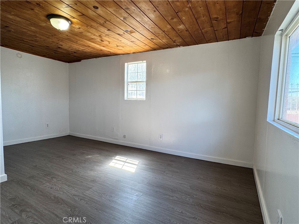 36528 Irwin Road Barstow, CA 92311 - Photo 5 of 35 an empty room with wooden floor and windows