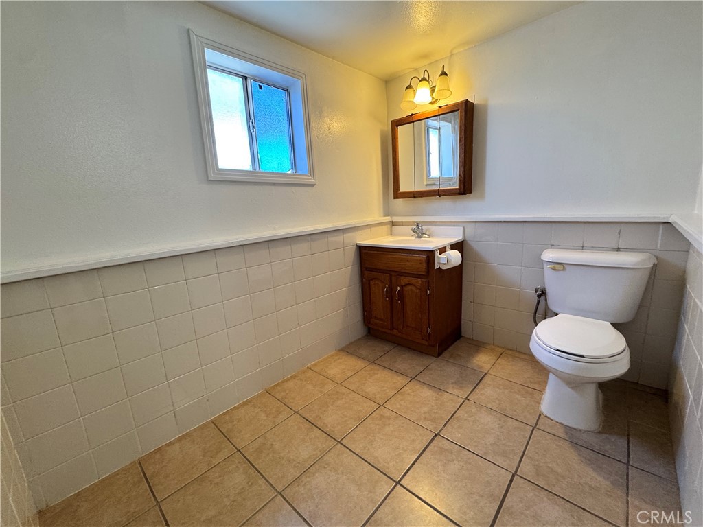 36528 Irwin Road Barstow, CA 92311 - Photo 9 of 35 a bathroom with a toilet sink and mirror