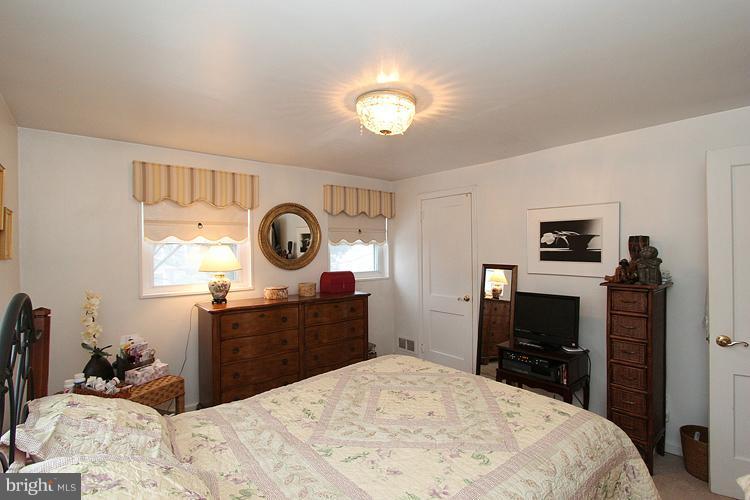 11942 Bluhill Road Silver Spring, MD 20902 - Photo 14 of 30 a bed room with a bed and a television