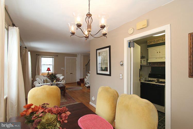 11942 Bluhill Road Silver Spring, MD 20902 - Photo 17 of 30 a living room with furniture a chandelier and a mirror