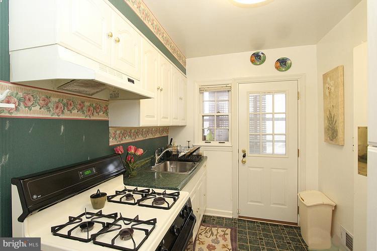 11942 Bluhill Road Silver Spring, MD 20902 - Photo 18 of 30 a kitchen with a refrigerator and a stove