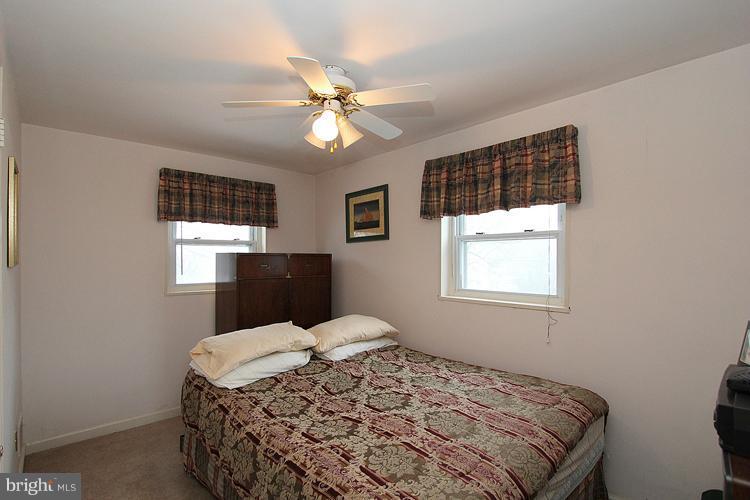 11942 Bluhill Road Silver Spring, MD 20902 - Photo 19 of 30 a bedroom with a bed and a window