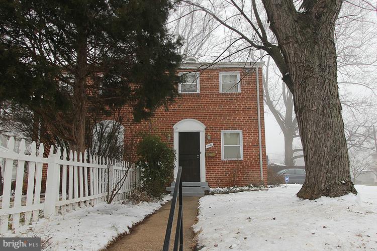 11942 Bluhill Road Silver Spring, MD 20902 - Photo 21 of 30 a front view of a house with a yard covered in snow