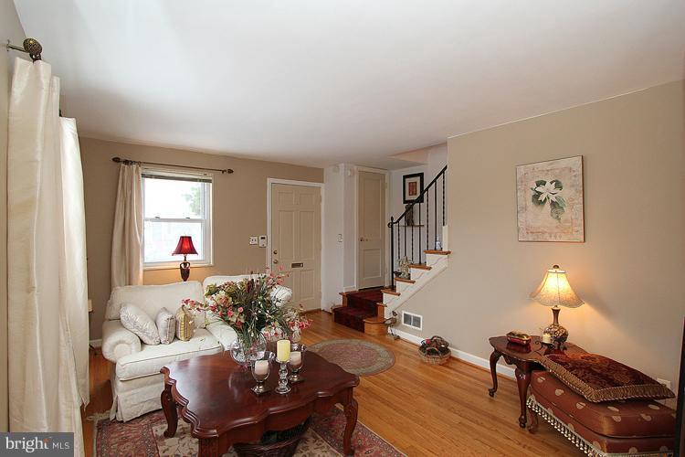 11942 Bluhill Road Silver Spring, MD 20902 - Photo 22 of 30 a living room with furniture a lamp and a window