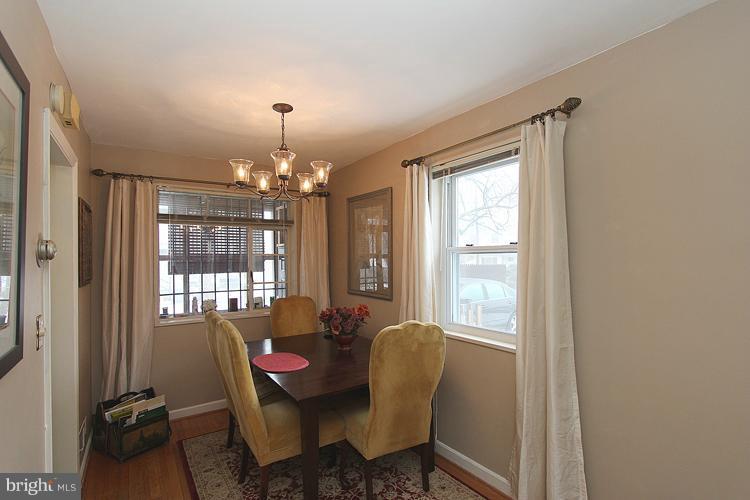 11942 Bluhill Road Silver Spring, MD 20902 - Photo 24 of 30 a dining room with furniture a chandelier and window