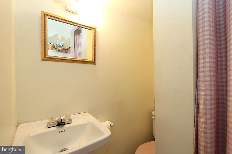 11942 Bluhill Road Silver Spring, MD 20902 - Photo 26 of 30 a bathroom with a sink and a toilet