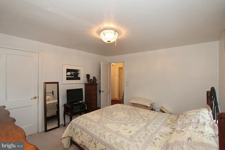 11942 Bluhill Road Silver Spring, MD 20902 - Photo 28 of 30 a bedroom with a bed and a television