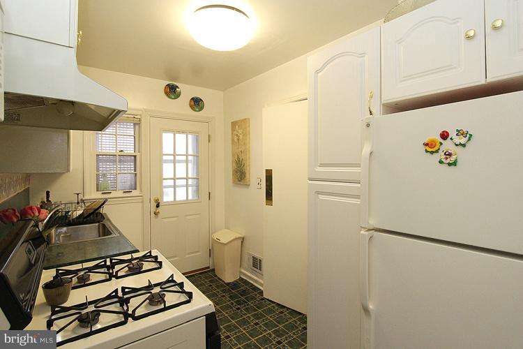 11942 Bluhill Road Silver Spring, MD 20902 - Photo 6 of 30 a kitchen with a refrigerator and a stove