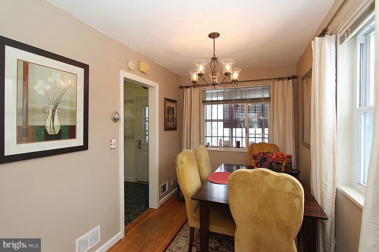 11942 Bluhill Road Silver Spring, MD 20902 - Photo 10 of 30 a view of a dining room with furniture wooden floor and chandelier