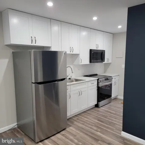a kitchen with a refrigerator stove and a sink