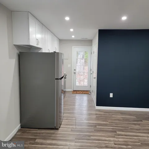 a view of a kitchen with a refrigerator and window