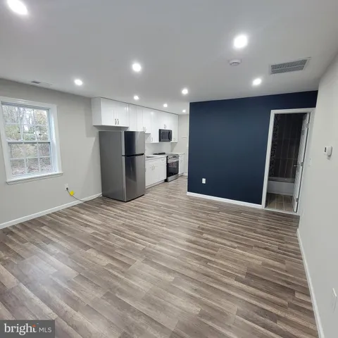 a view of a kitchen with a refrigerator and a window