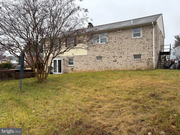 a view of a brick house with a yard
