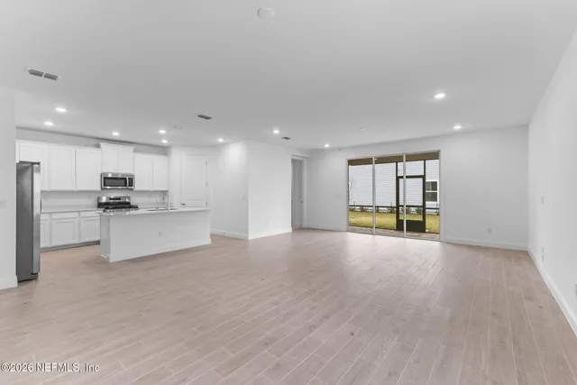 a view of a kitchen with a sink and a refrigerator