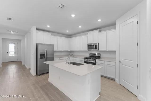 a kitchen with sink and window