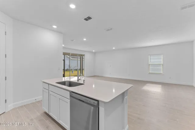 a bathroom with a bathtub double vanity sink and a mirror