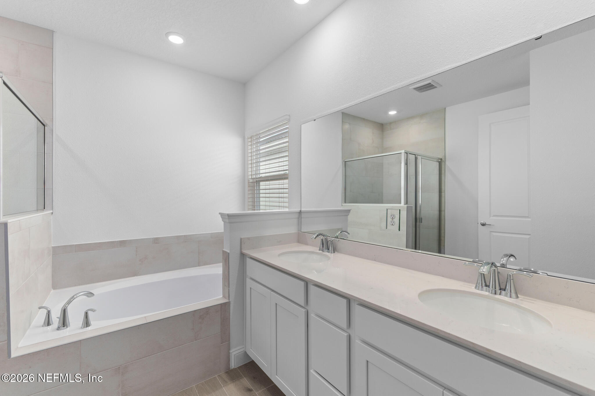 299 Pentwater Road St. Augustine, FL 32092 - Photo 21 of 25 a bathroom with a bathtub double vanity sink and a mirror