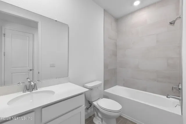 an empty room with a window and a bathroom