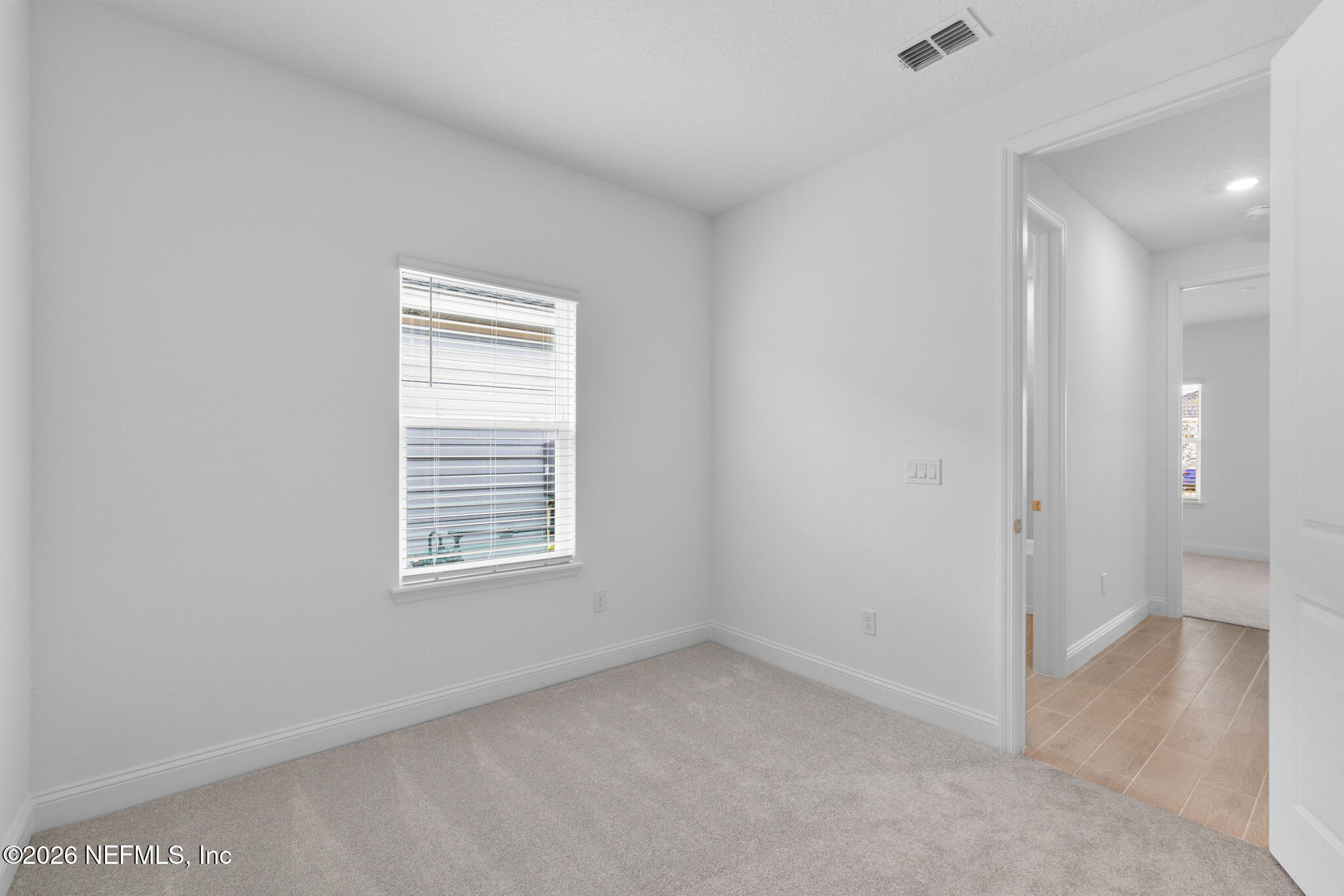 299 Pentwater Road St. Augustine, FL 32092 - Photo 7 of 25 an empty room with a window and a bathroom