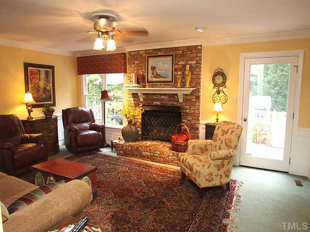 1308 Swindon Court Raleigh, NC 27615 - Photo 9 of 25 a living room with furniture a fireplace and a window