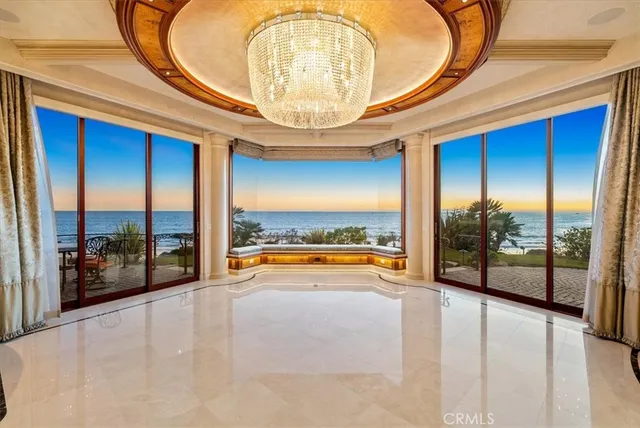 a spacious bedroom with a bed and a large mirror on the dresser