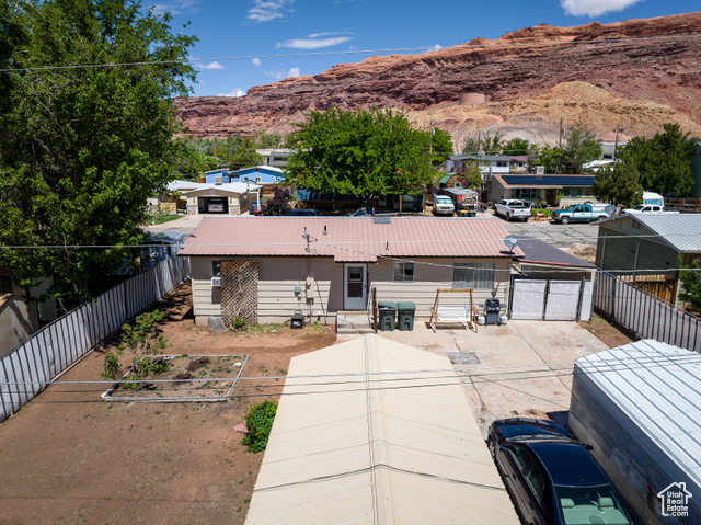 527 Palisade Drive Moab, UT 84532 - Photo 35 of 51 View of rear of home with a mountain view and a fenced backyard