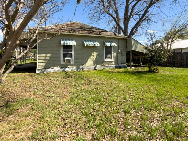 a view of a house with backyard porch and sitting area