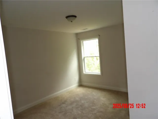 a view of an empty room and a window