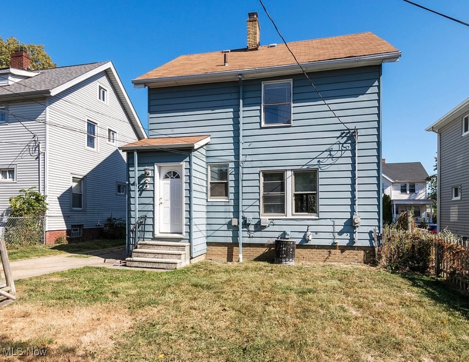 17710 Crestland Road Cleveland, OH 44119 - Photo 2 of 28 Rear view of house with a chimney and entry steps