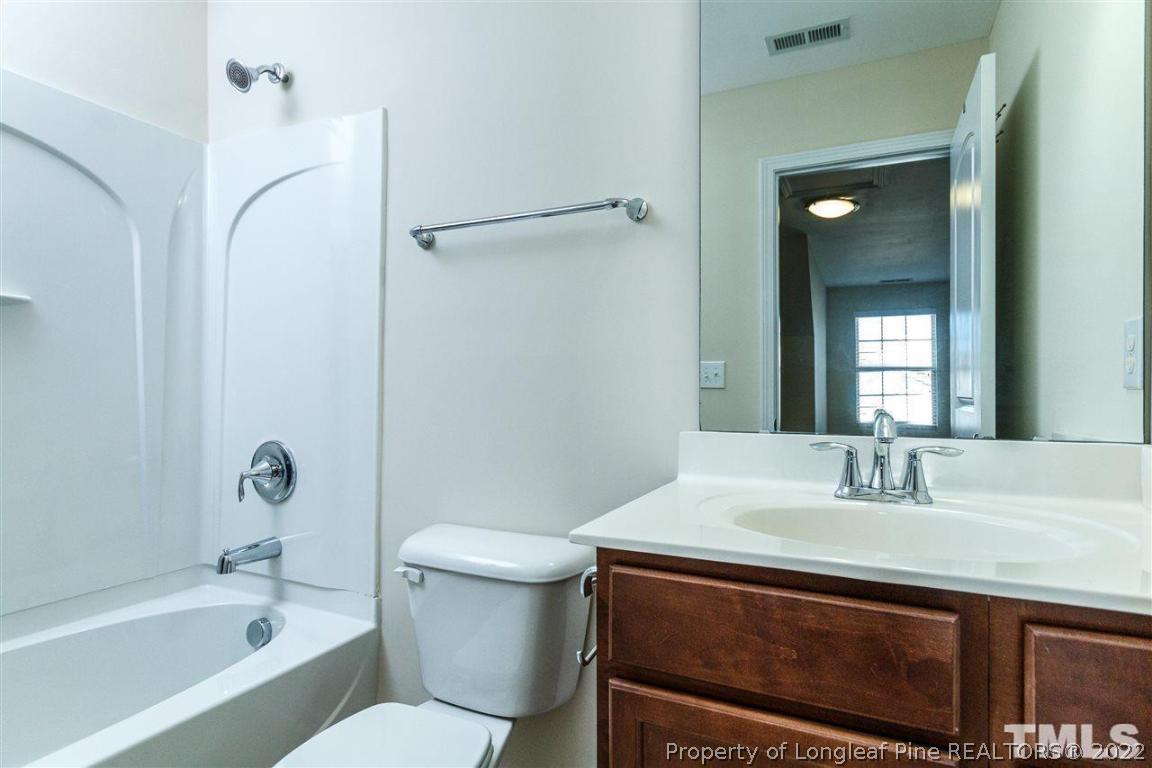 110 Mt Evans Drive Durham, NC 27705 - Photo 13 of 27 a bathroom with a sink a toilet and shower