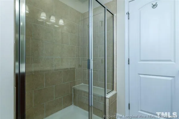 a bathroom with a glass shower door