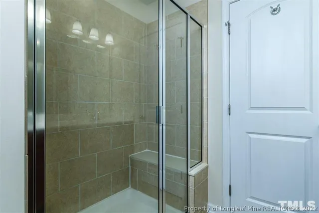 a bathroom with a glass shower door