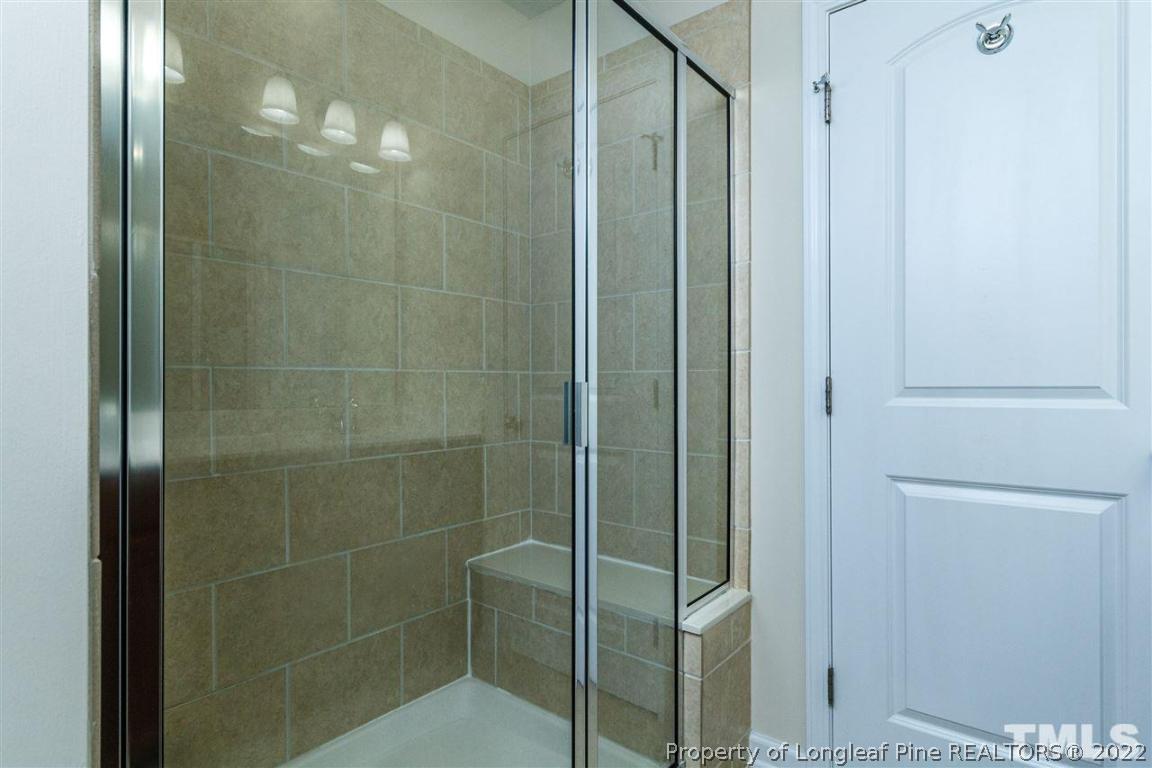 110 Mt Evans Drive Durham, NC 27705 - Photo 18 of 27 a bathroom with a glass shower door