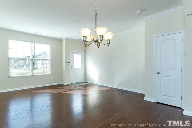 a view of a room with wooden floor and a window