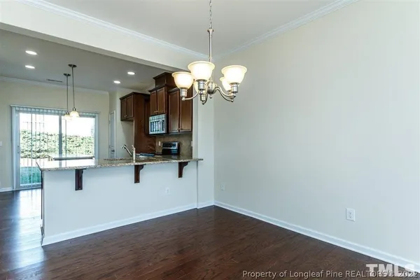 a view of a room with wooden floor and windows