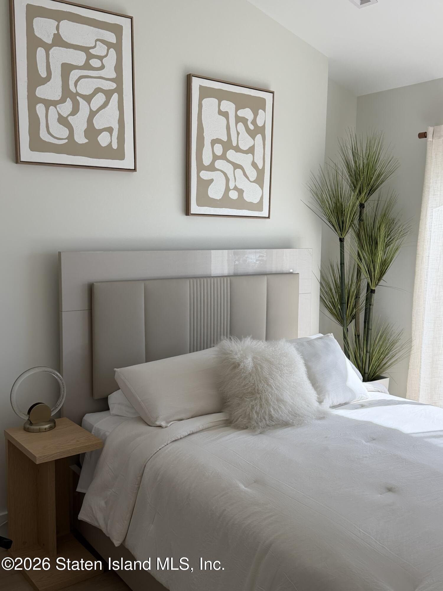 1239 Forest Hill Road, Unit 21 Staten Island, NY 10314 - Photo 11 of 15 a bedroom with a bed and a potted plant