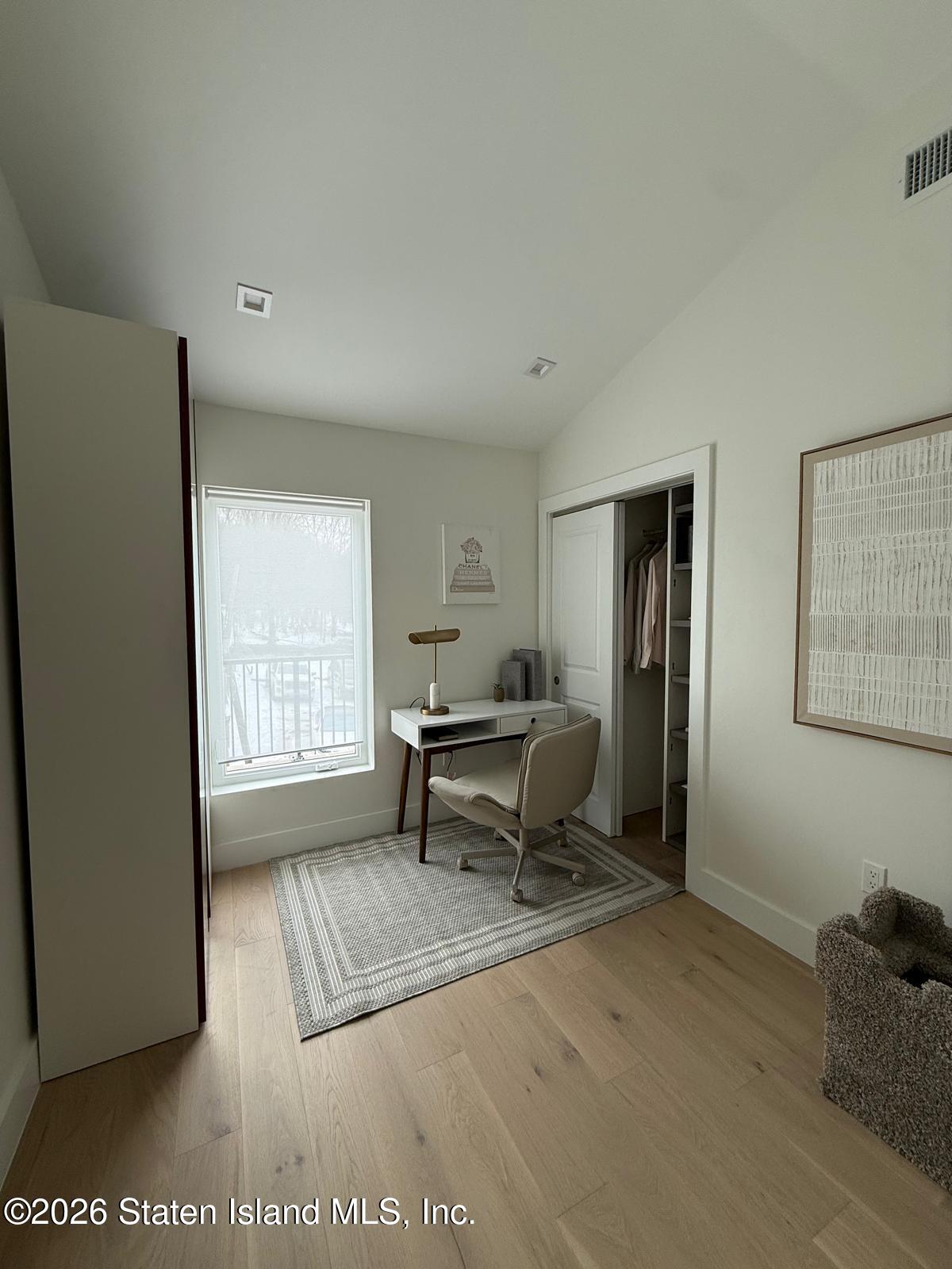 1239 Forest Hill Road, Unit 21 Staten Island, NY 10314 - Photo 12 of 15 a living room with furniture a window and a table