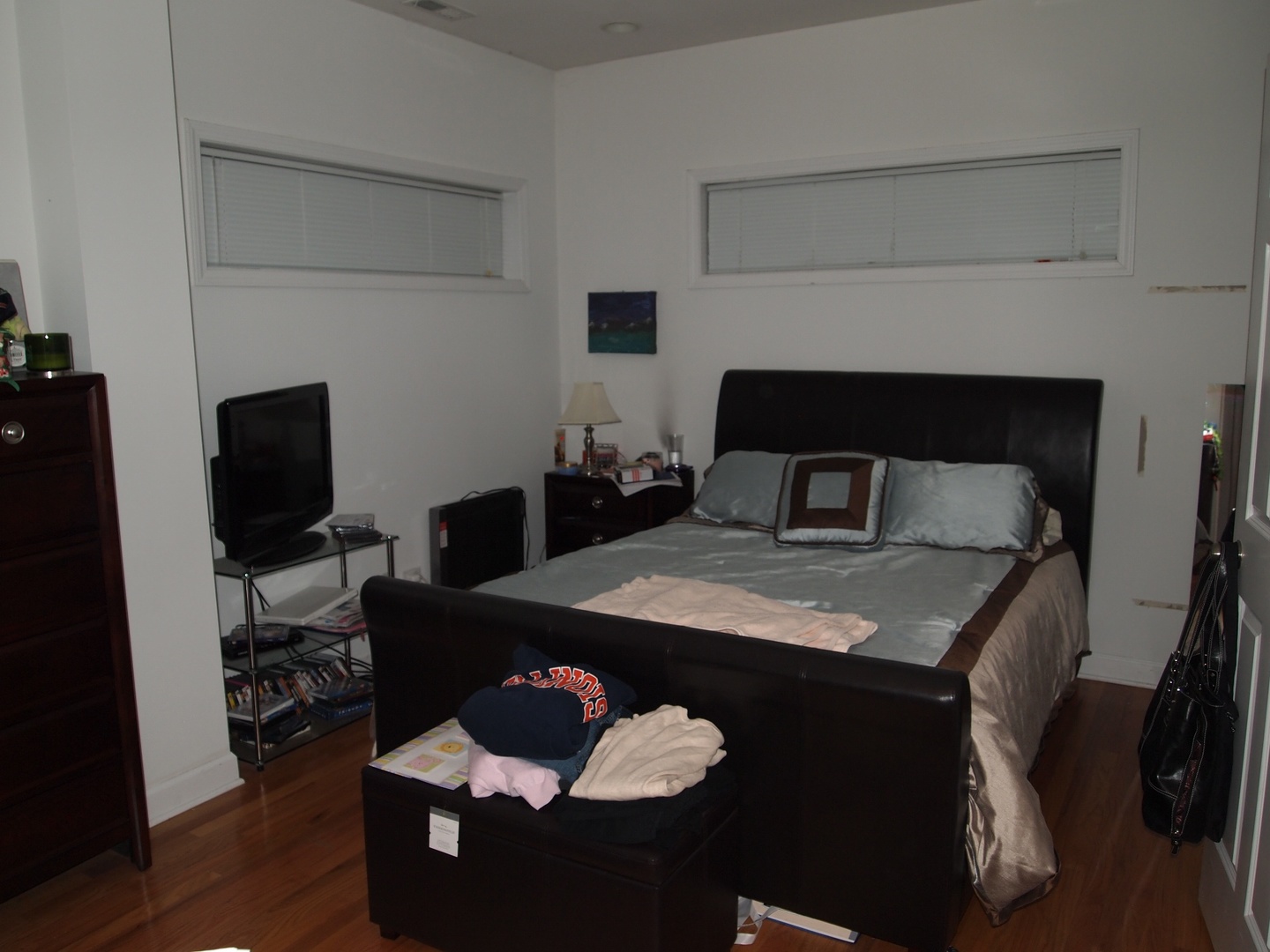 1330 West Roscoe Street, Unit 2 Chicago, IL 60657 - Photo 10 of 11 a bedroom with a bed and wooden floor