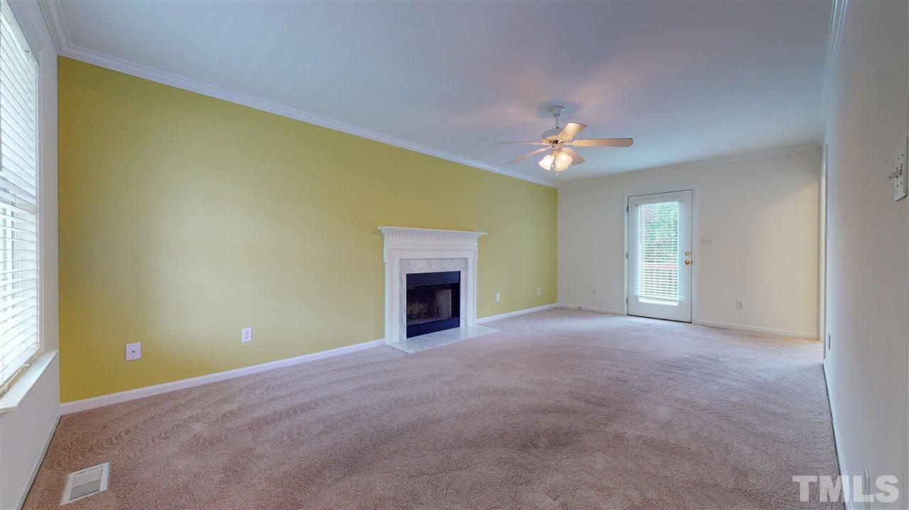 4840 Topstone Road Raleigh, NC 27603 - Photo 11 of 30 a view of empty room with fireplace and fan