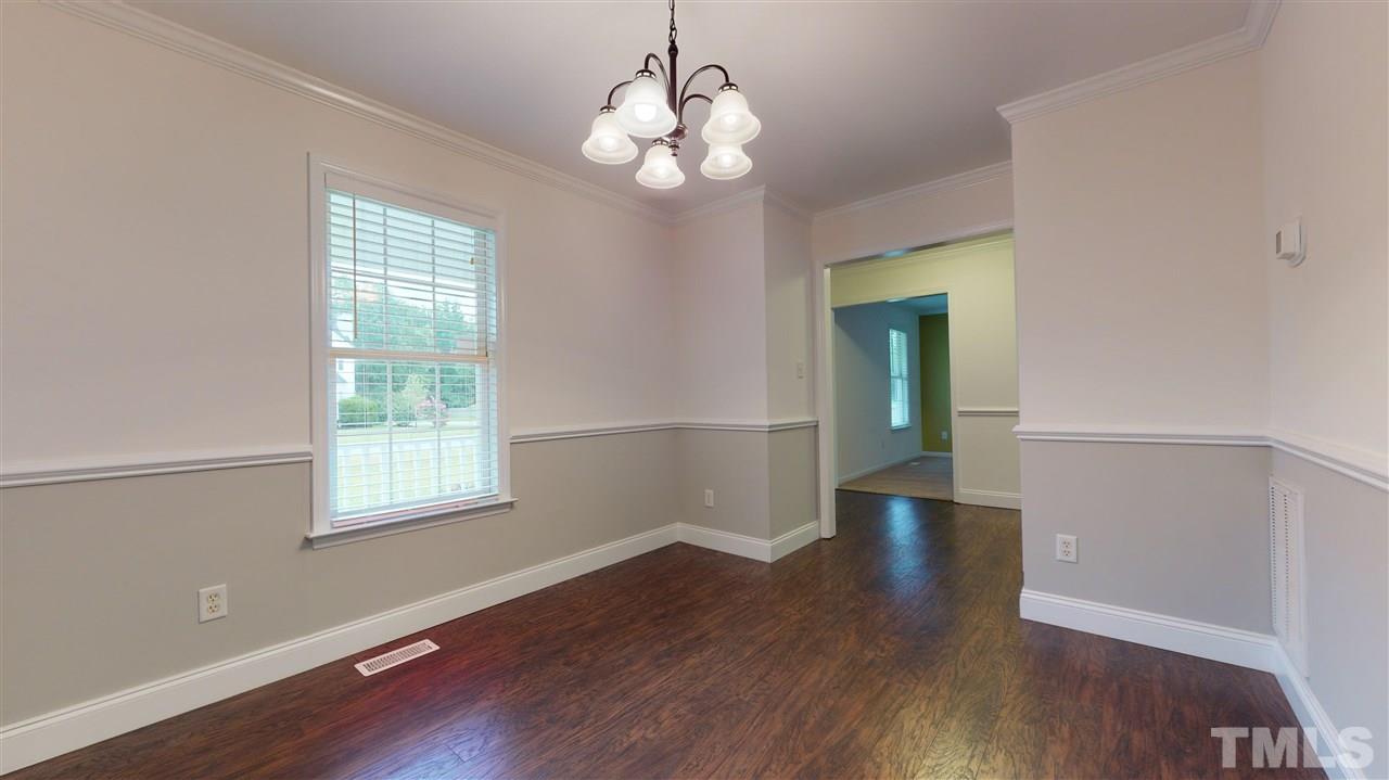4840 Topstone Road Raleigh, NC 27603 - Photo 13 of 30 an empty room with wooden floor and windows