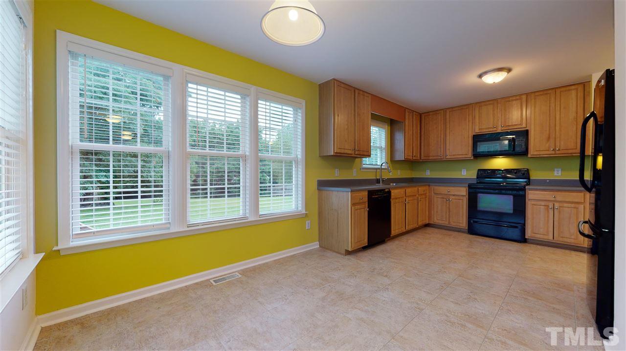 4840 Topstone Road Raleigh, NC 27603 - Photo 15 of 30 a kitchen with stainless steel appliances granite countertop a stove and a sink