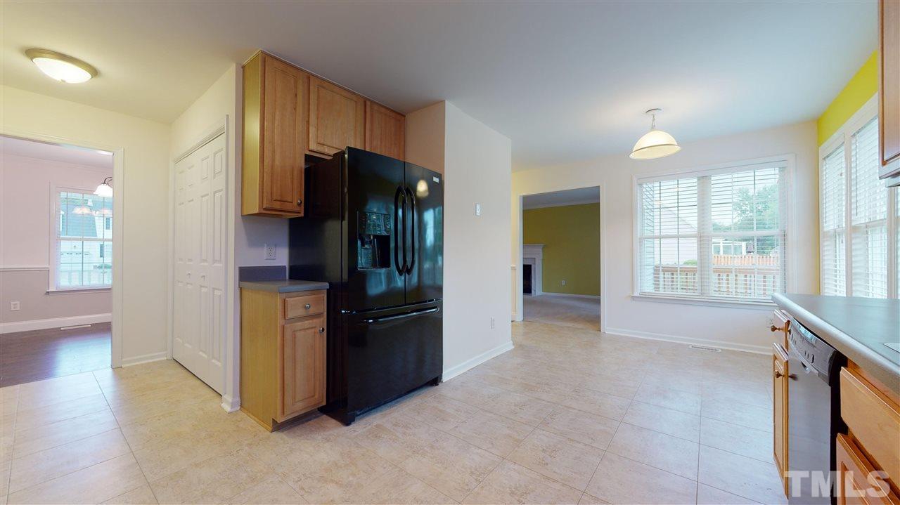 4840 Topstone Road Raleigh, NC 27603 - Photo 17 of 30 a view of an empty room with a kitchen and a window