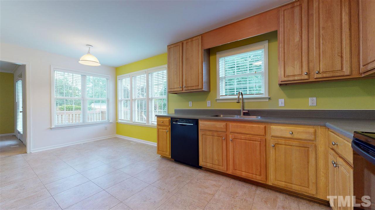 4840 Topstone Road Raleigh, NC 27603 - Photo 18 of 30 a kitchen with stainless steel appliances granite countertop a sink a stove a granite counter tops and a window