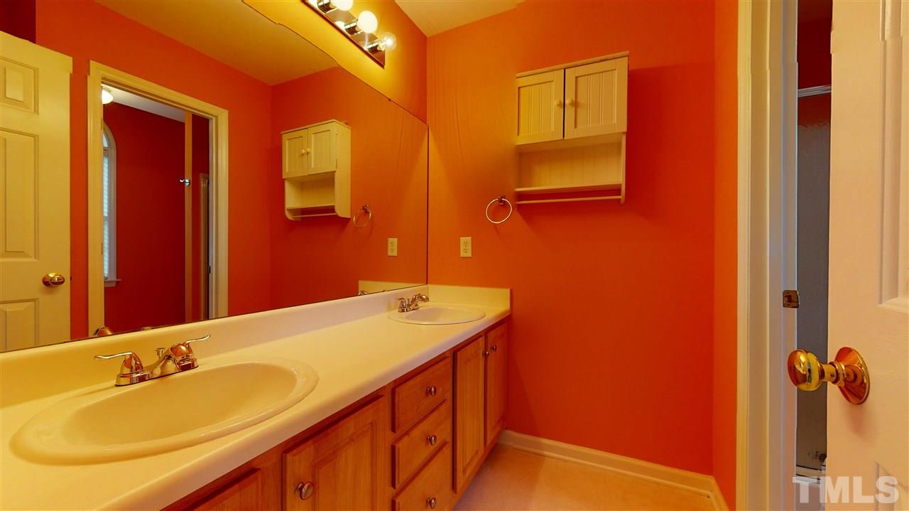 4840 Topstone Road Raleigh, NC 27603 - Photo 21 of 30 a bathroom with a sink and a mirror